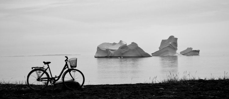 A bike parked up in front of some icebergs